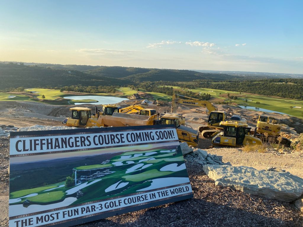 Construction equipment at Cliffhangers Par-3 Course site at Big Cedar Lodge with preview sign overlooking Payne’s Valley in Ridgedale, Missouri.