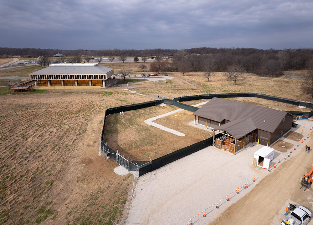 Aerial view of St. Louis Zoo WildCare Park construction site in North St. Louis County, showing animal habitat fencing and repurposed buildings.