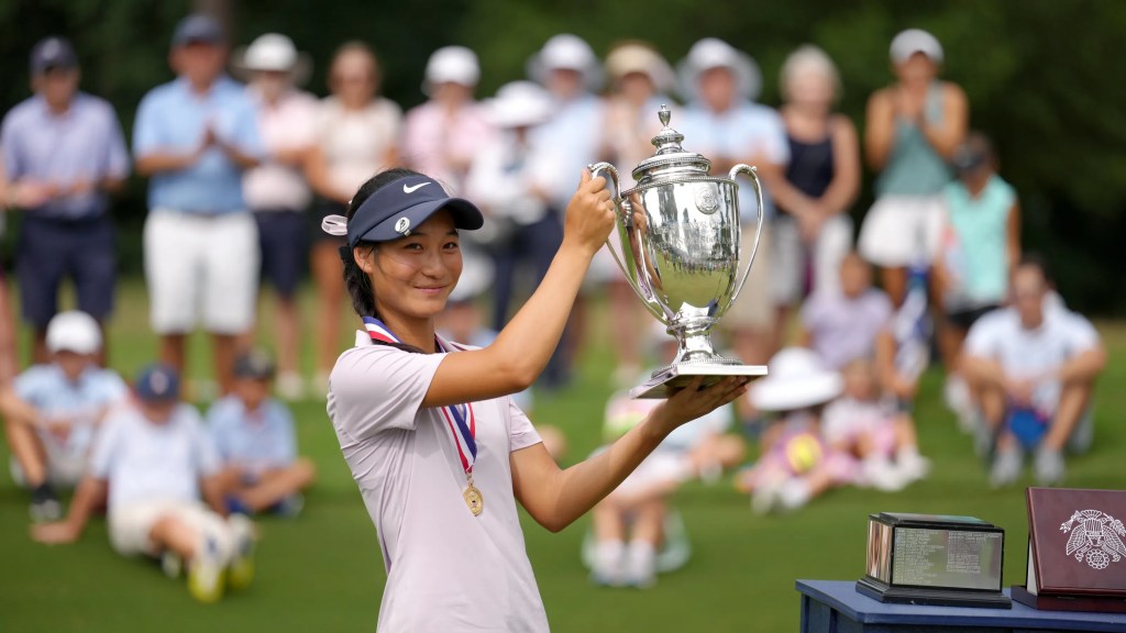 Aphrodite Deng smiles with her trophy and medal after winning the 2024 U.S. Girls' Junior Championship at the USGA event.