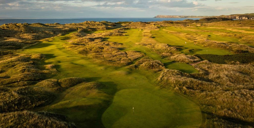 Aerial view of the Dunluce Links at Royal Portrush Golf Club overlooking the North Atlantic Ocean