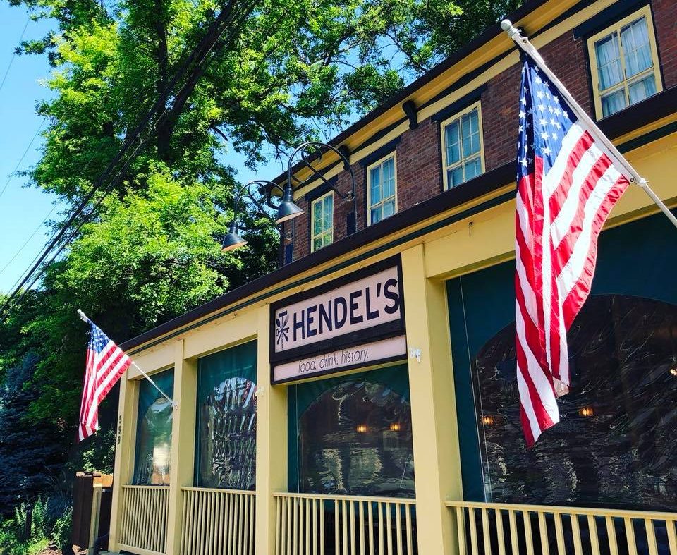 Exterior of Hendel's Restaurant in Florissant, Missouri, with American flags and historic building architecture